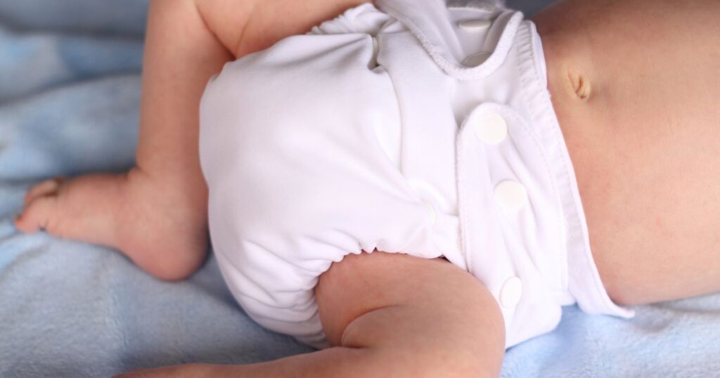 keep-cloth-diapers-white-baby-laying-down-in-a-white-cloth-diaper