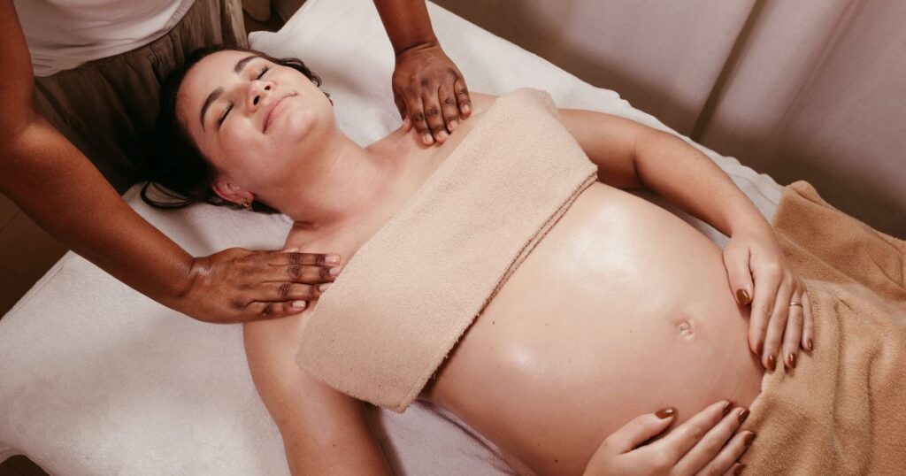maternity-massage-therapist-Charlotte-NC-pregnant-woman-getting-a-maternity-massage-relaxing