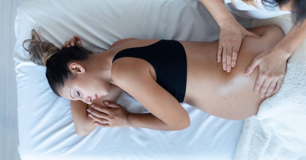 maternity-massage-therapist-giving-a-pregnant-woman-a-massage