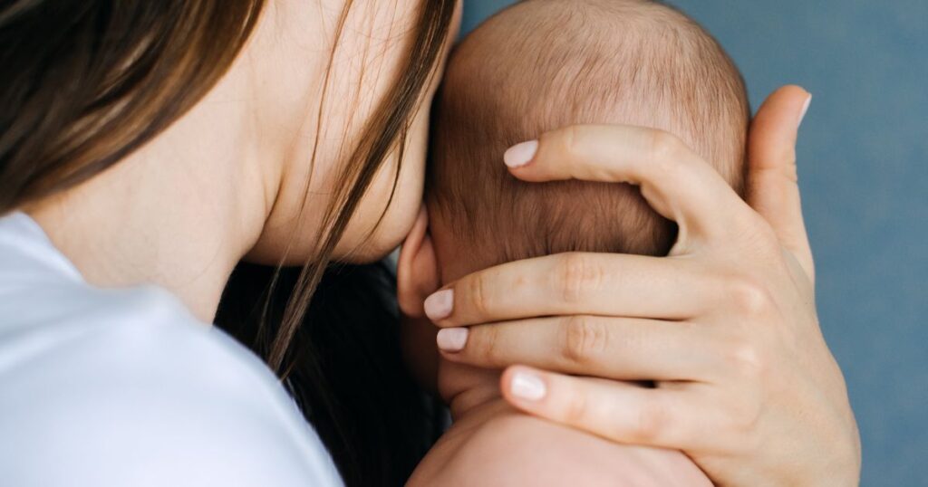 mother-holding-her-baby-closely