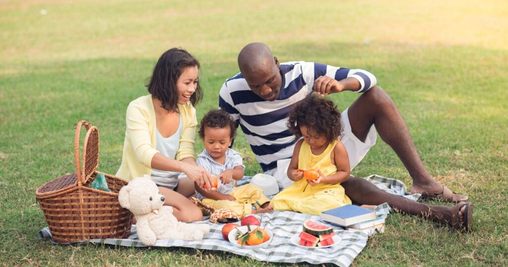 things-to-do-in-charlotte-with-kids-mom-and-dad-with-children-having-a-picnic