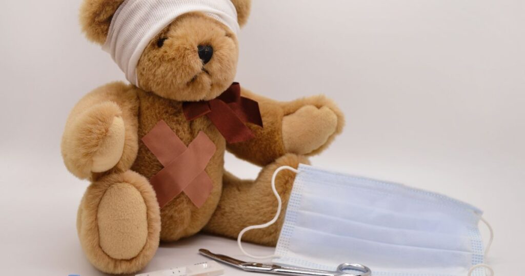 Stuffed-teddy-bear-with-bandages-medical-mask-and-instruments-symbolizing-childrens-healthcare