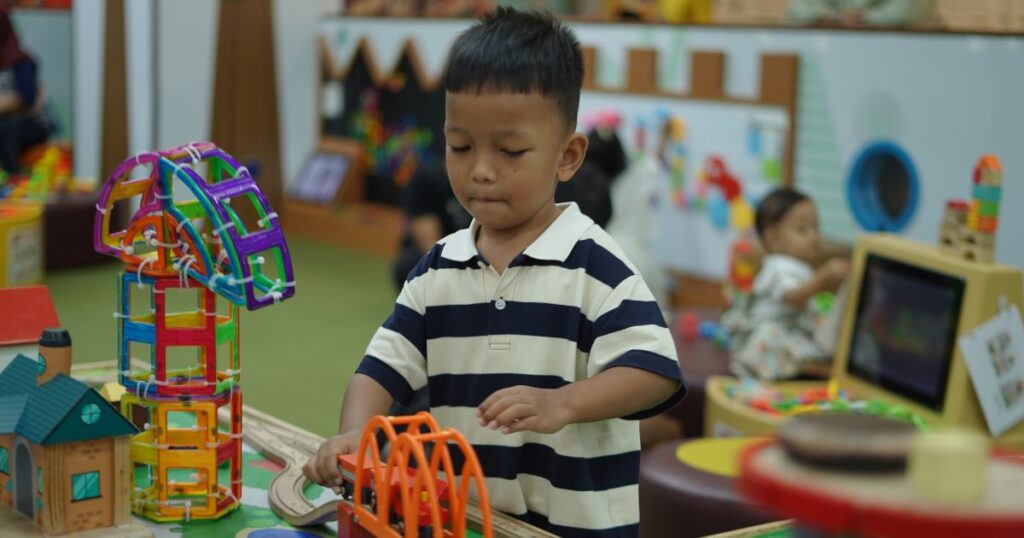 Toddler-activities-Charlotte-NC-with-child-playing-at-indoor-learning-center-with-blocks-and-trains