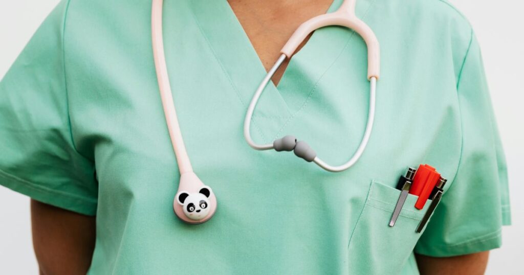 Close up image of a hospital care professional wearing scrubs and stethoscope with panda shaped cover