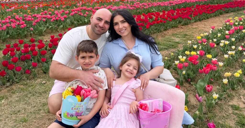 Aleks Manucharov and his family enjoying spring tulips after moving to the Charlotte area