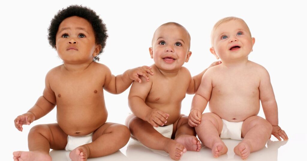 Babies sitting together with diaper on