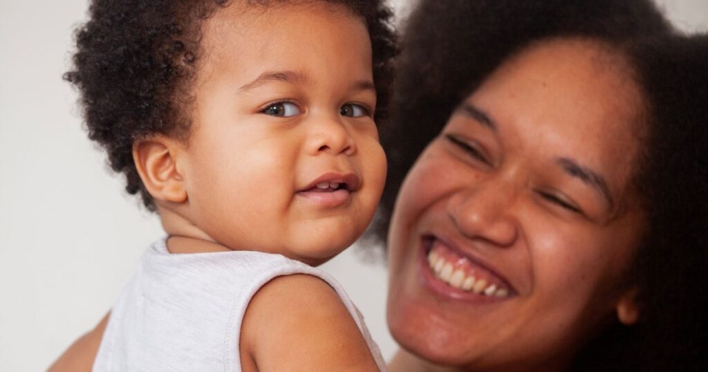 Close up image of mom and baby smilling