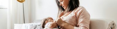 new mom breastfeeding at home